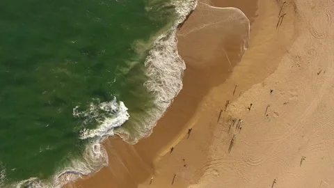 Aerial pan over waves breaking on the shore Stock Footage 157130972