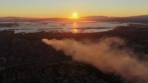 Aerial Pan Over Wildfire Smoke Drifting Across American Canyon Homes at Sunset 動画素材 341840420