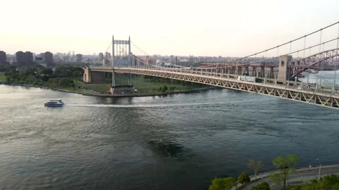 Aerial Pan from RFK Bridge, Tracking Ferry Boat to NYC Skyline @ Sunset 4K Drone Stock Footage 165248174