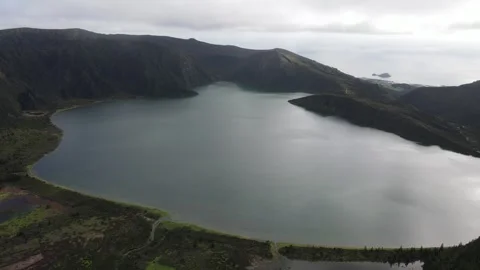 Aerial pan right from Lagoa do Fogo crater lake to the Atlantic Ocean, 4K 30fps. Stock Footage 333366029
