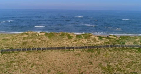 Aerial Pan Right to Left of Exploring the Magnificent Beach Area of Porto Stock Footage 113937401