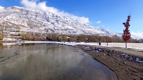 Aerial Pan Right to Left over Pond with Mountains Vídeos de archivo 77112920