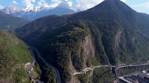 Aerial pan right from pristine mountains to polluted valley Video stock 152047261