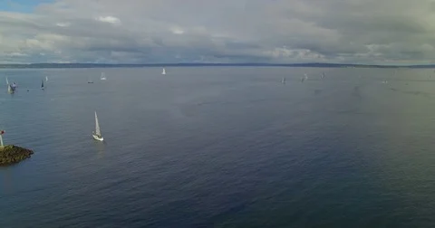 Aerial Pan Right to Reveal Multiple Sailboats in Distance Video stock 75954616