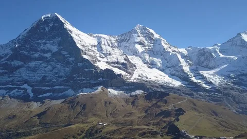 Aerial Pan Shot Of Eiger Mountain and Green Grindlewald Valley, Swizterland Stock Footage 97206623