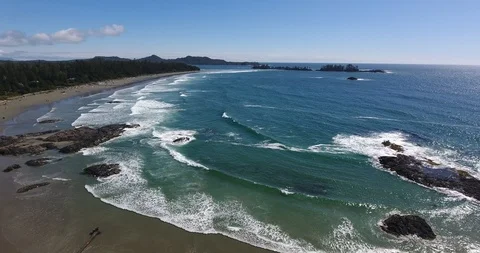 Aerial Pan Shot of waves breaking on beach Stock Footage 106848751