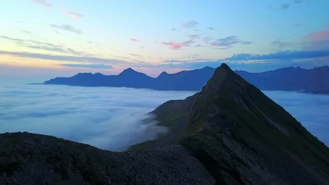 Aerial Pan: Thick Cloud Among Scenic Cliffs at Dusk in Senja Island, Norway Stock Footage 106509665