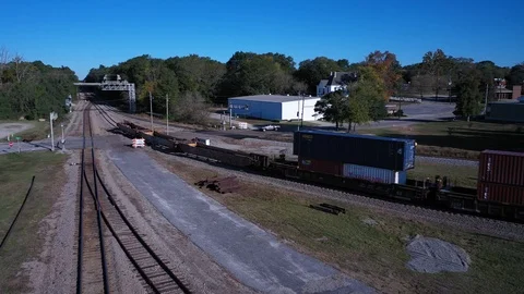 Aerial pan of a train moving down the tracks Stock Footage 119704808