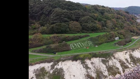 Aerial pan of Ventnor coastal cliffs and rocky coastline, Isle of Wight Stock Footage 337032862