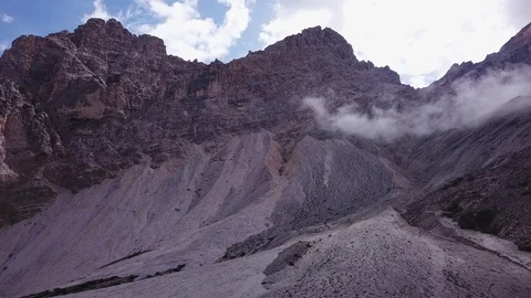Aerial pan view of the mountains Dolomites Fanes valley, sunny summer morning Stock Footage 114357792