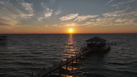Aerial pan view of sunset off Mobile Bay, Alabama Stock Footage 221813362
