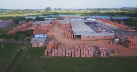 Aerial pan of yard with stacks of brick and pottery in fabrication Stockbeeldmateriaal 125198377