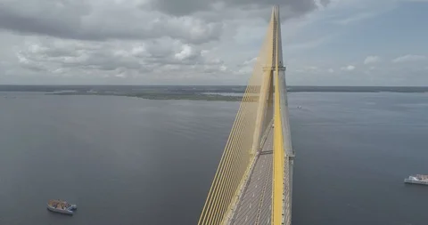 Aerial panning around the cable-stayed Rio Negro Bridge that links the cities of 스톡 동영상 101294060