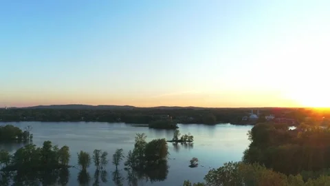 Aerial panning down over the river in Laval during a beautiful sunset 動画素材 136417516