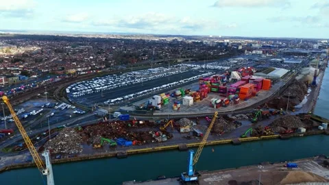 Aerial panning high angle drone shot over cargo ship loading bay on river in Video stock 331126979