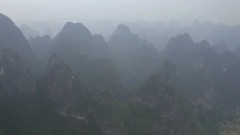 Aerial Panning: Idyllic mountain range in foggy weather - Xingping, China Stock Footage 149686887
