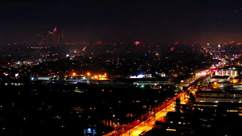 Aerial Panning Shot Of Fireworks Exploding In City At Night, Drone Flying Over Stock Footage 243881754