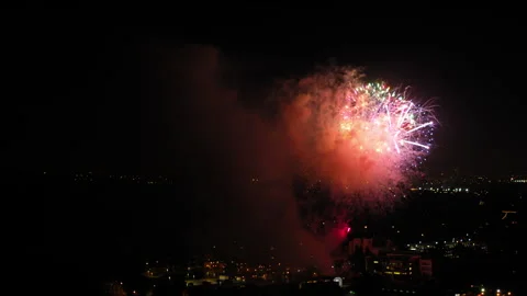 Aerial Panning Shot Of Fireworks Exploding On Residential Buildings, Drone Stock Footage 243882013
