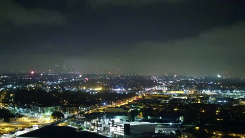 Aerial Panning Shot Of Fireworks Exploding In Residential City At Night - Los Stock Footage 264045543