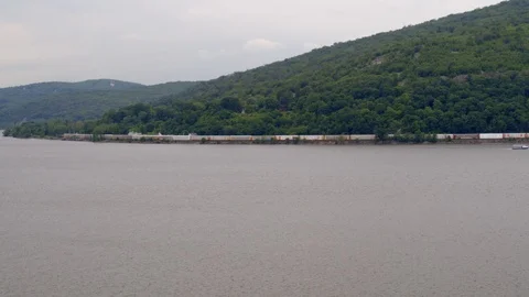 Aerial Panning Shot of Train Passing by the Hudson River Stock Footage 94657251