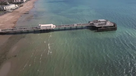 Aerial panning view of the beach and the pier in Worthing Stock Footage 67850149