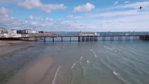 Aerial panning view of the beach and the pier in Worthing, Southern England Stock Footage 69239458