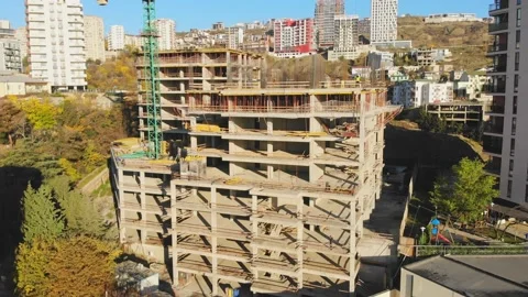 Aerial panning view construction site with crane cary block material and work Stock-Footage 188034514