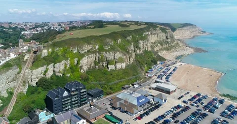 Aerial panning view of the old town of Hastings in England and the beach Stock Footage 79687020