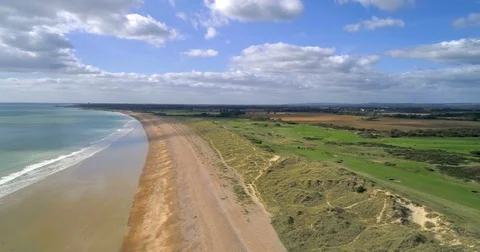 Aerial panning view of a seaside links golf course in Southern England Stock Footage 80983220