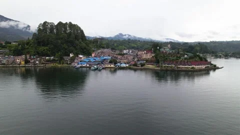 Aerial panning view of settlements around the lake Stock Footage 259004979