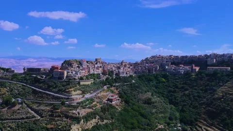 Aerial panning view of the town of Centuripe in Sicily revealing Mount Etna Stock Footage 305652643