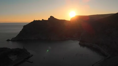 Aerial panorama of dramatic beautiful sunset over mountains and sea harbor Video stock 107495915