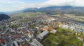 Aerial panorama of modern town in green Alpine valley, beautiful mountain nature 4k or 4k+ Resolution