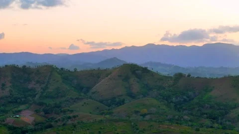Aerial panorama of mountain range layers in green valley at sunset. Beautiful Stock Footage 272953928