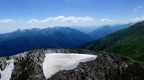 Aerial panorama mountain range valley 4k video Caucasus Georgia hikers in peak Stock Footage 68459004