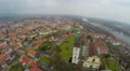 Aerial panorama of old city downtown, city hall tower, mountains on horizon 4k or 4k+ Resolution