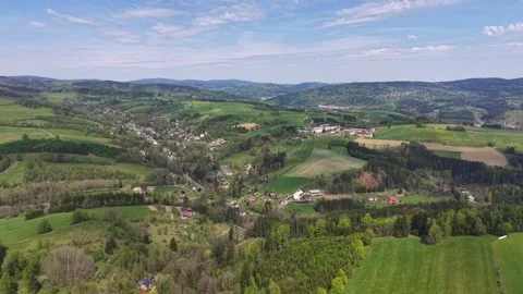 Aerial panorama over patchwork countryside with rolling green hills, village Stock Footage 342358491