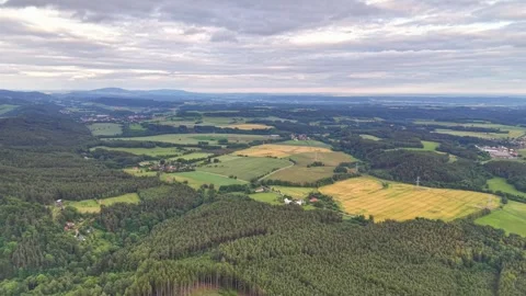 Aerial panorama over patchwork fields, dense forests, scattered farmsteads, Stock Footage 342355376