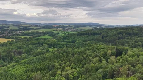 Aerial panorama of patchwork fields and forest edges with rolling green hills Stock Footage 346261760