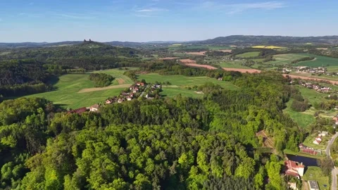 Aerial panorama of patchwork fields, forests, villages, rolling hills, stone Stock Footage 342358633