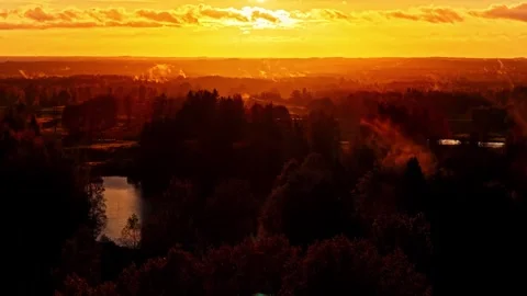 Aerial panorama of a river cutting through forest in red dusk light Stock Footage 329143550