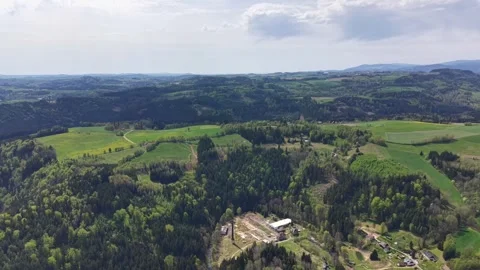 Aerial panorama of rolling countryside with patchwork fields, forests, village Stock Footage 342355292