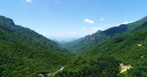 Aerial panorama of wide primitive forest between two mountains Qinling Shaanxi Stock Footage 337925616