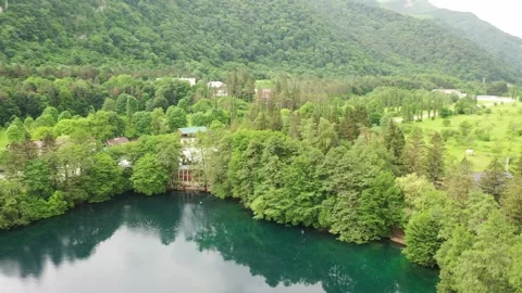 Aerial panoramic arc shot of the Blue Lake, Kabardino-Balkaria Stock Footage 338015070