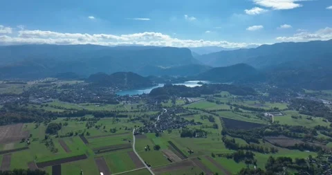 Aerial panoramic of Bled valley with patchwork fields, small village and Lake Stock Footage 333934148