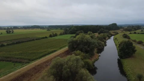 Aerial panoramic canal landscape over green meadows in summer Stock Footage 328613657