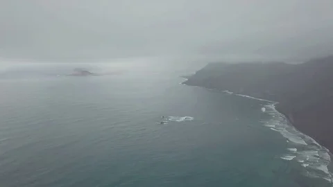Aerial panoramic footage camera flight above the foggy ocean Stock Footage 85299582