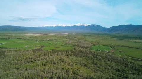 Aerial panoramic landscape of snow capped Sayan Mountains and the valley on a Video stock 211819982