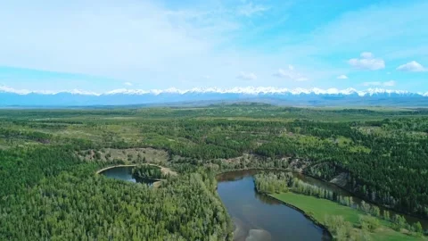 Aerial panoramic landscape of snow capped Sayan Mountains, valley and river on a Stock-Footage 211820896