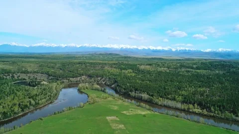 Aerial panoramic landscape of snow capped Sayan Mountains, valley and river on a Stock-Footage 211821041